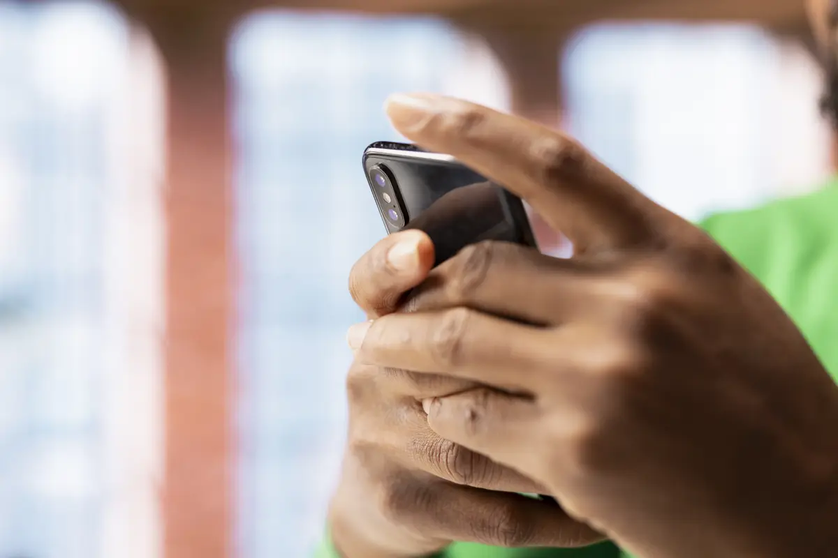 Man at home using smartphone to catch up with emails and reply back closeup