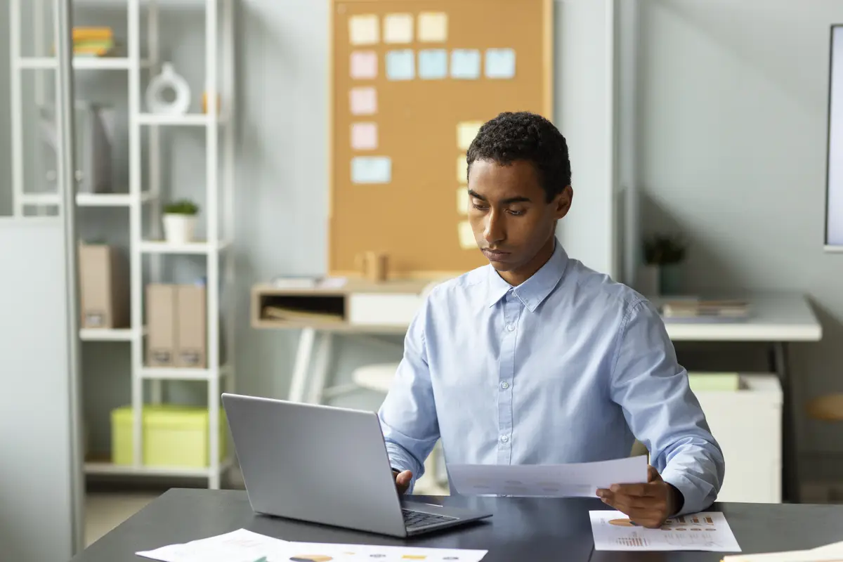 Medium shot man working on laptop