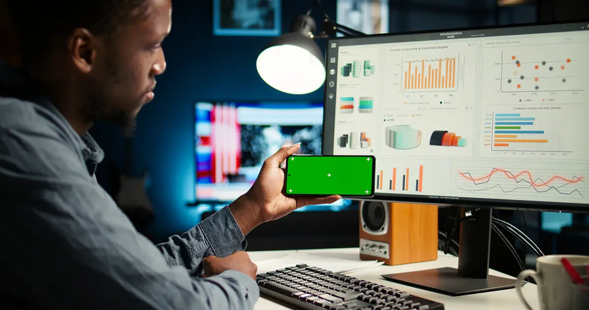 Young person does remote work using data finances with a green screen