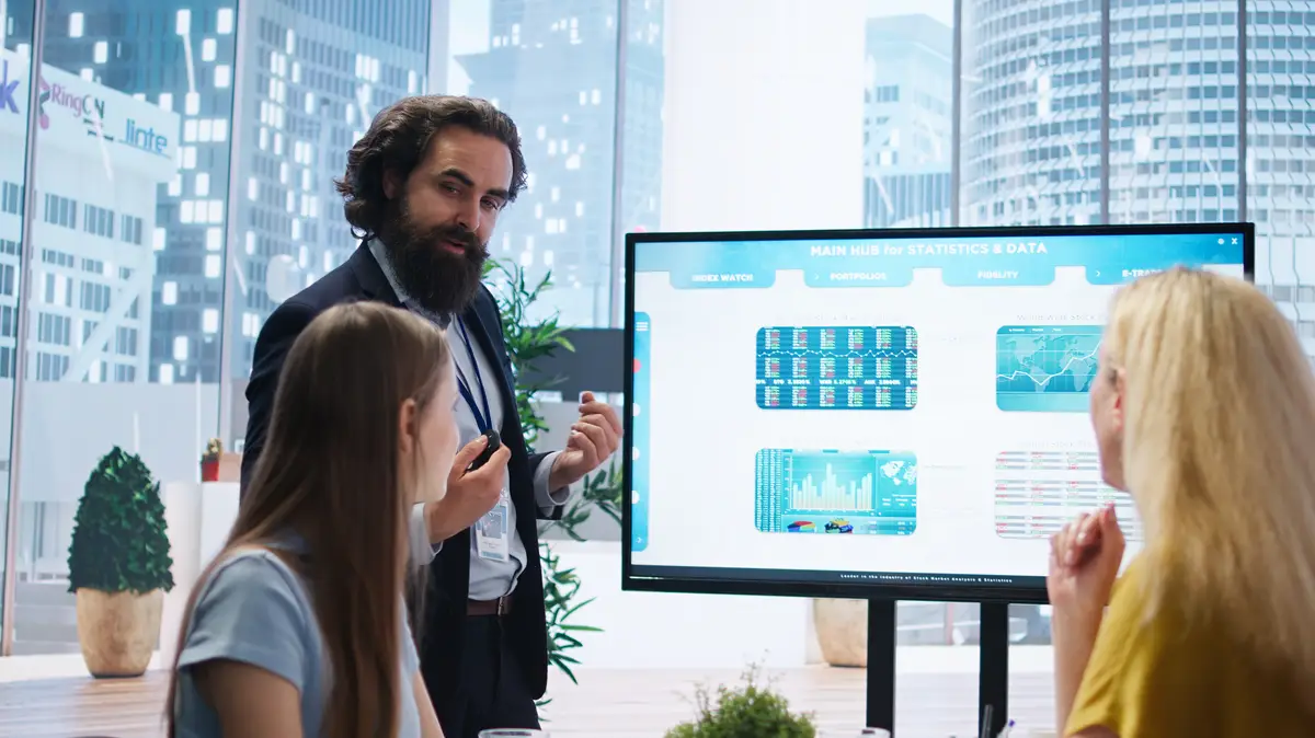 Financial advisor presents detailed stock market analysis to clients