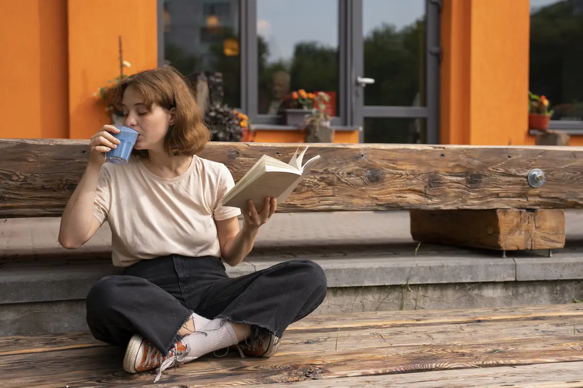 Full shot woman enjoying a blue matcha