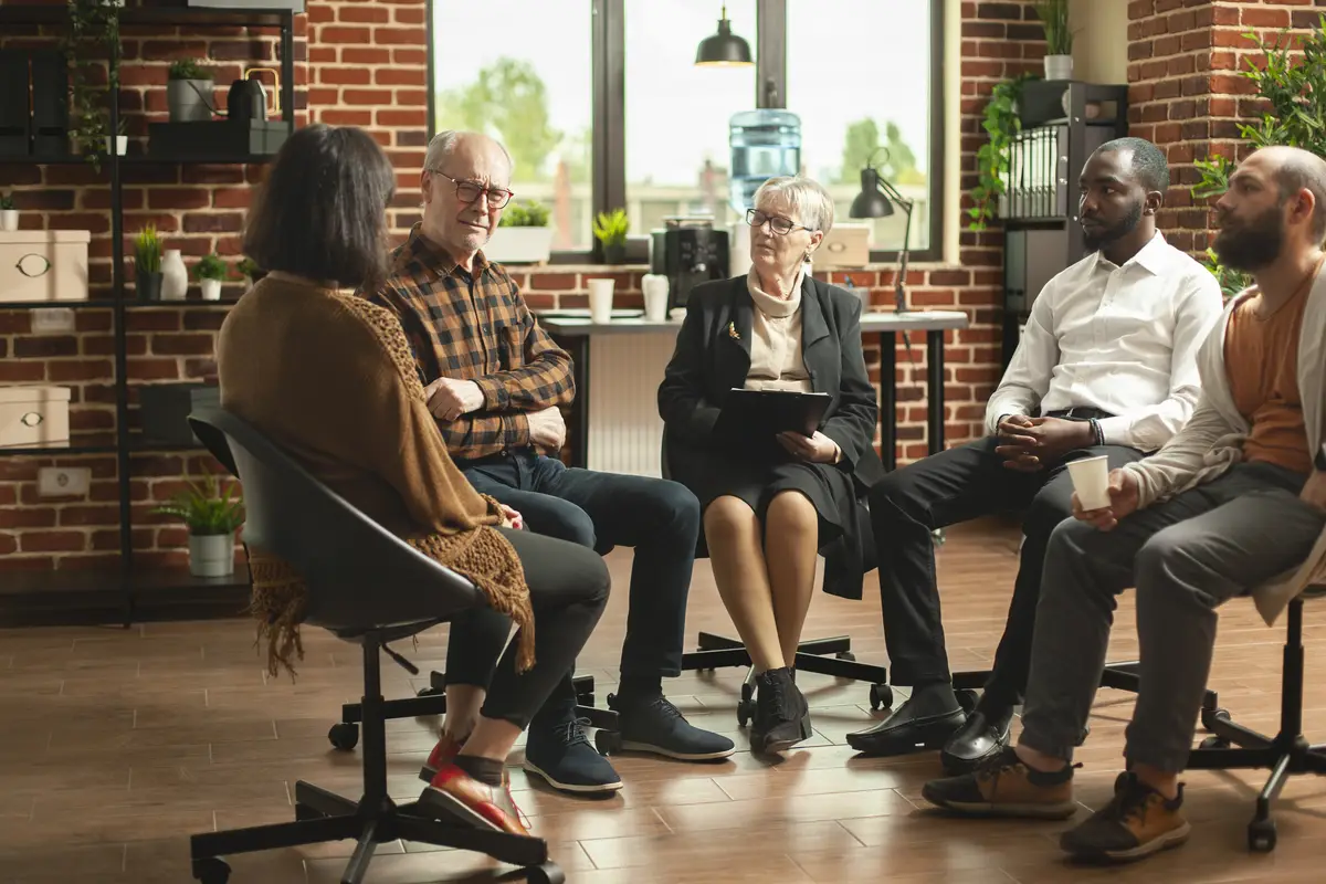 Psychologist advising group of patients