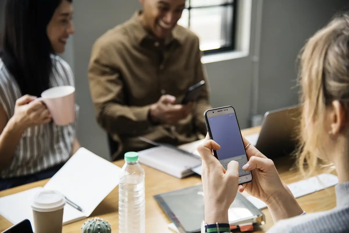 Woman playing in her phone in a meeting