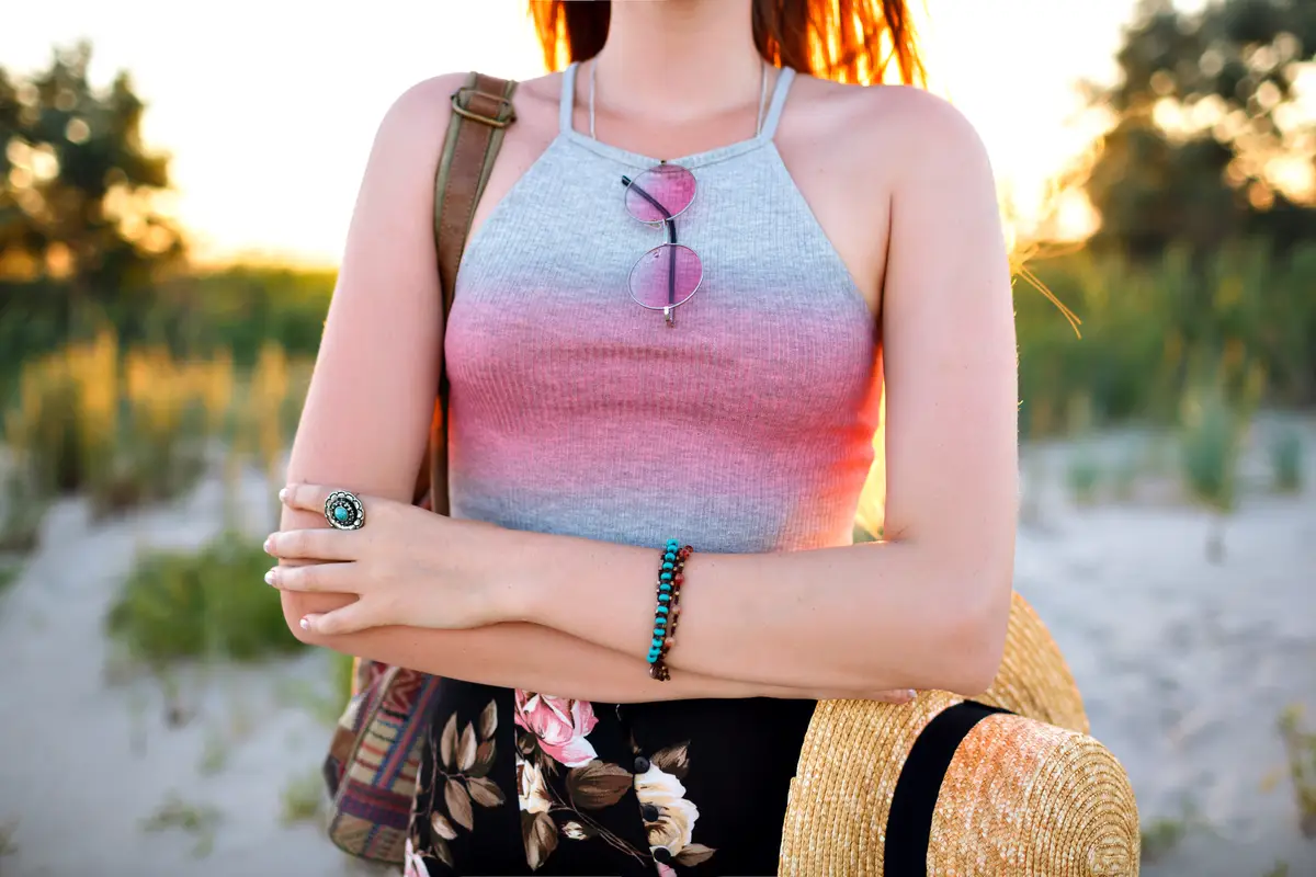Summer trendy fashion details, vintage style vibes, crop top, straw hat and backpack, boho chick style, free spirit.