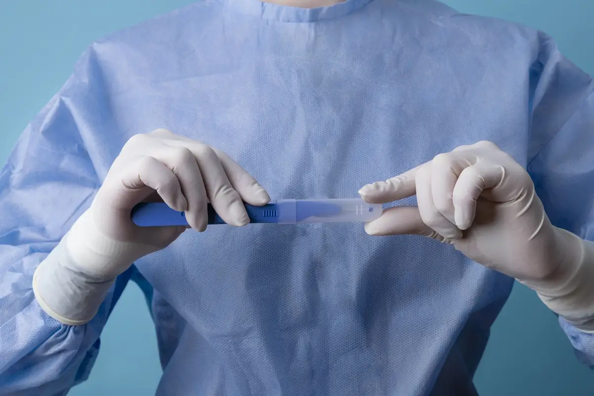 Female doctor holding metallic medical scalpel