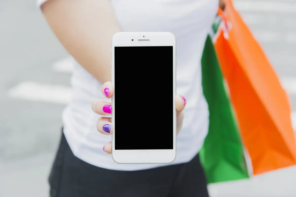 Female with phone and shopping bags