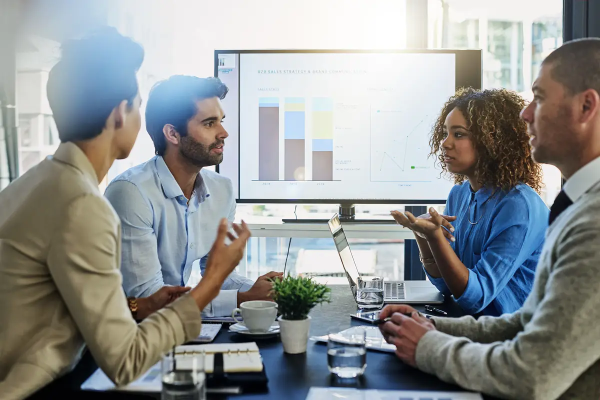 Business people screen and discussion with team in meeting presentation or conference at office Group of employees with finance graph chart or data in collaboration company investment or revenue