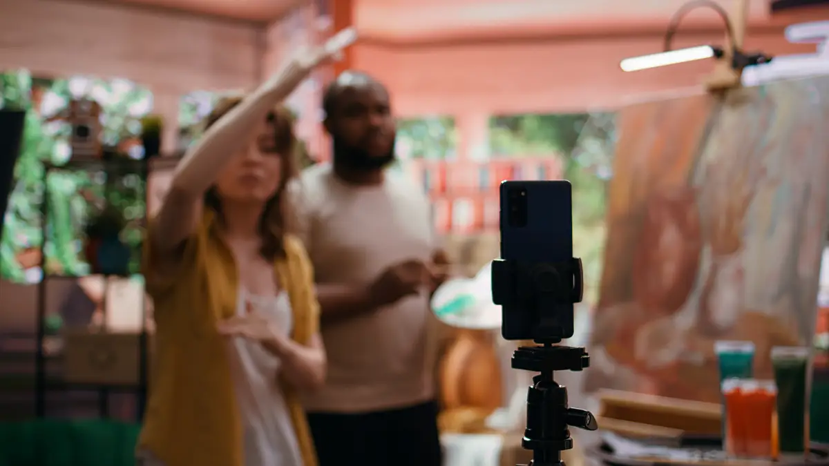 Female artist explaining painting techniques used on online tutorial