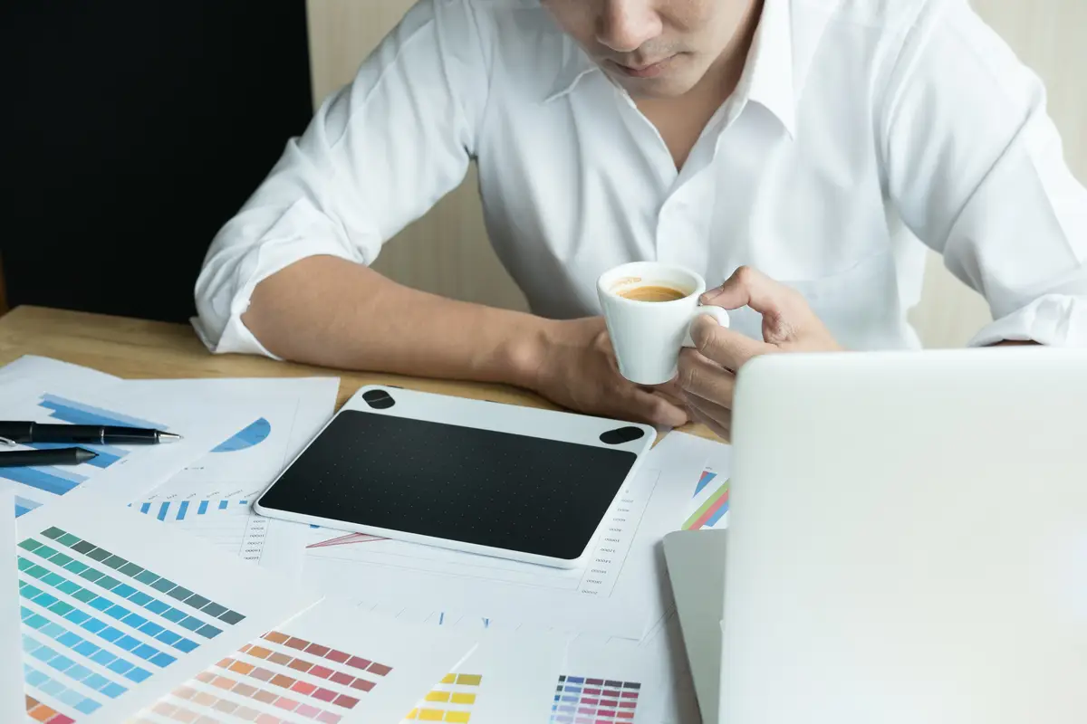 Low angle view of man using coffee cup on table