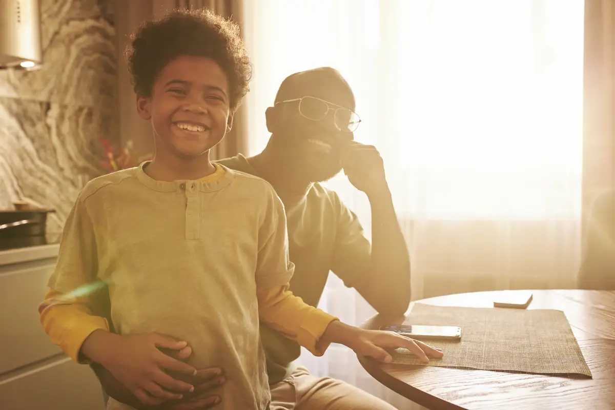Medium shot smiley man and kid at home