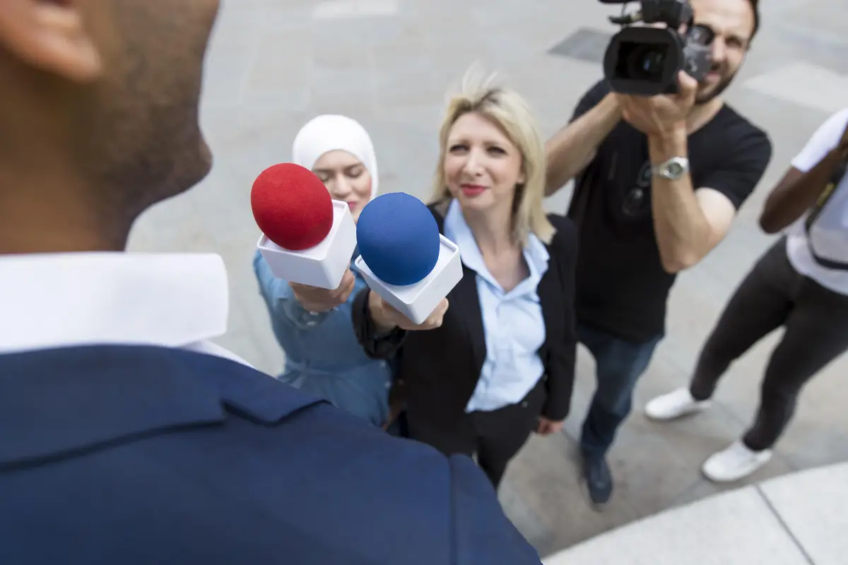 Close up on interviewee with microphone taking statements