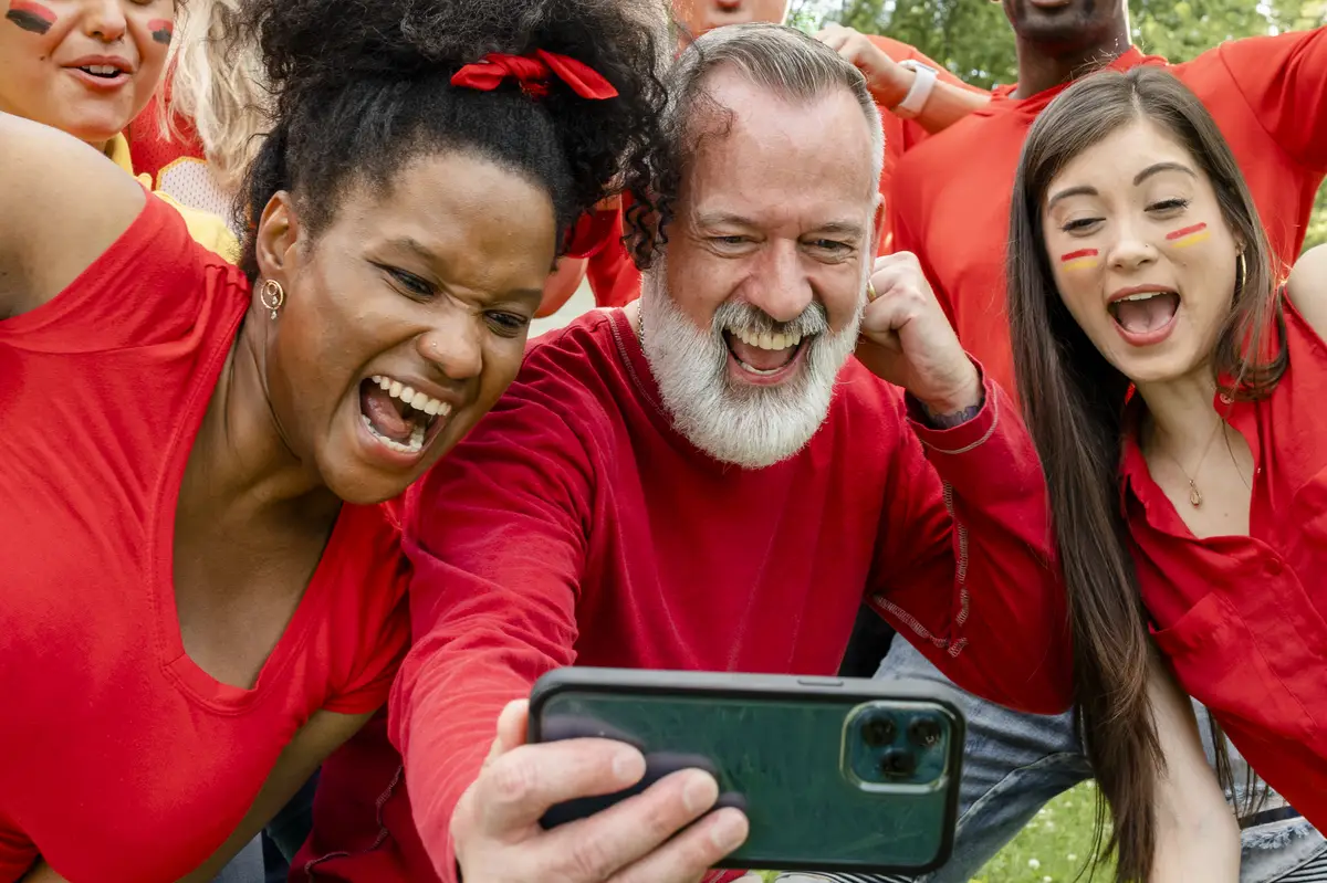Supporters watching their team win the game on a mobile phone