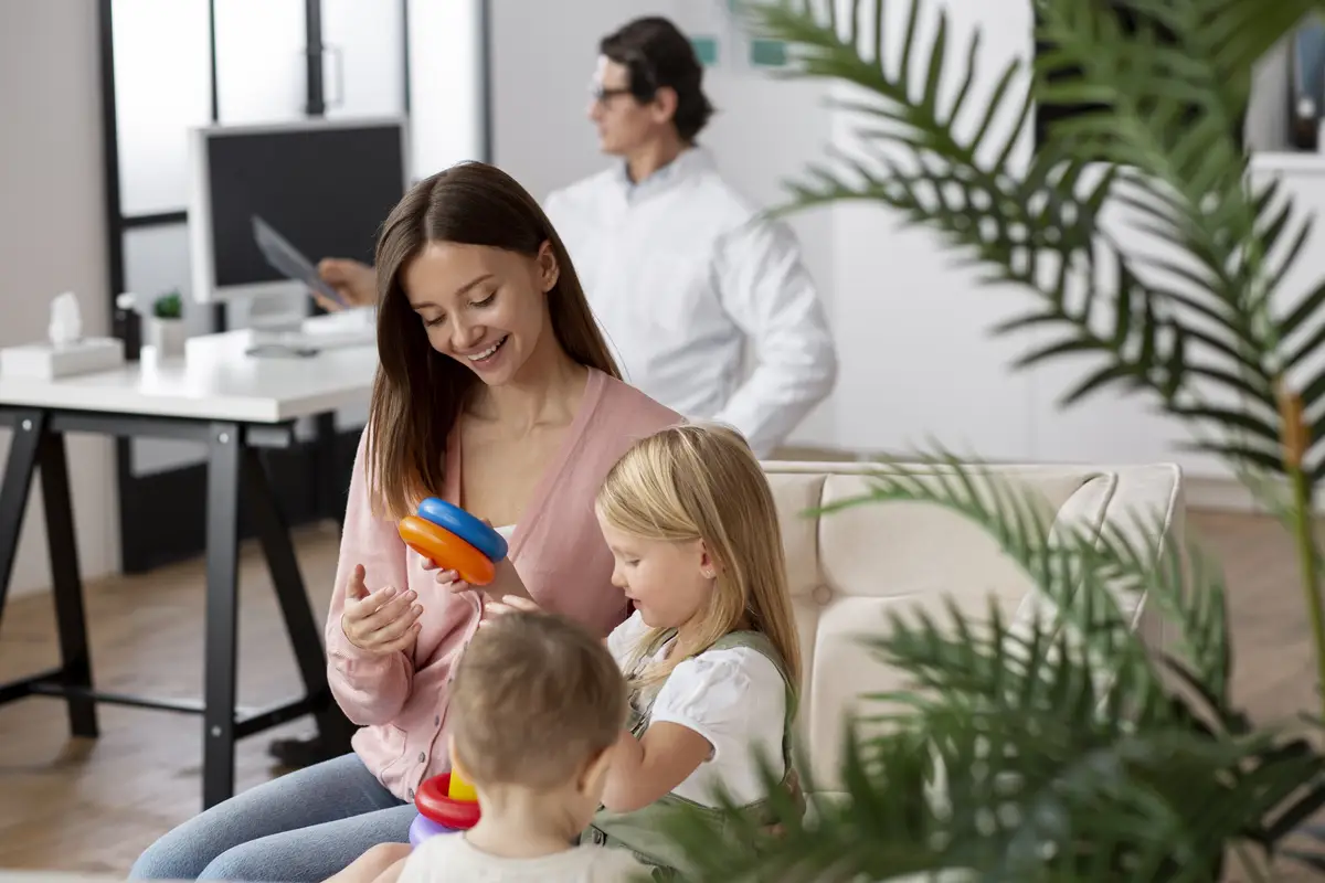 Young mother with her children at a pediatrician appointment
