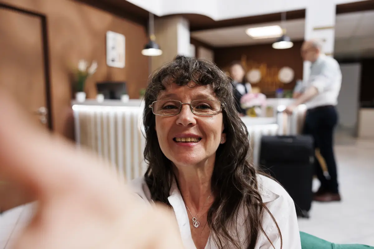 Cheerful old woman at hotel reception