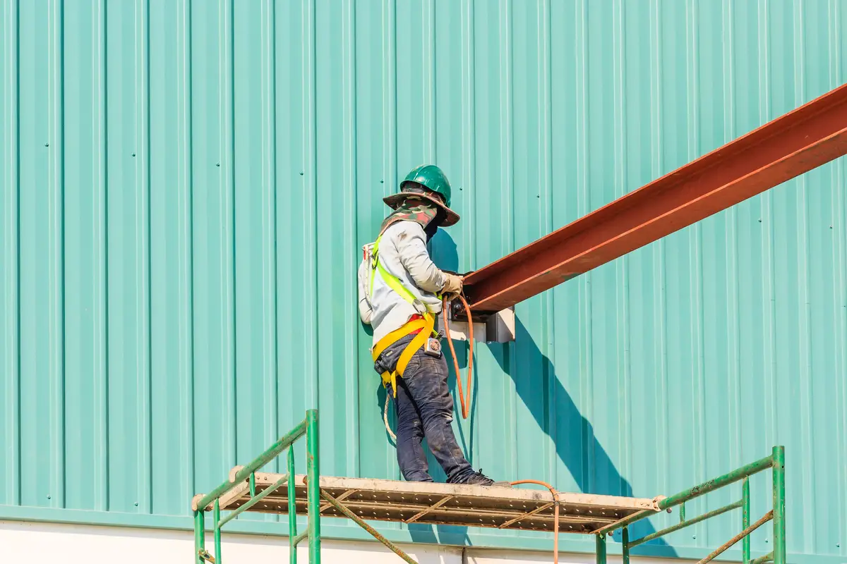 Technicians are welding steel structure. Construction site image for the background. 