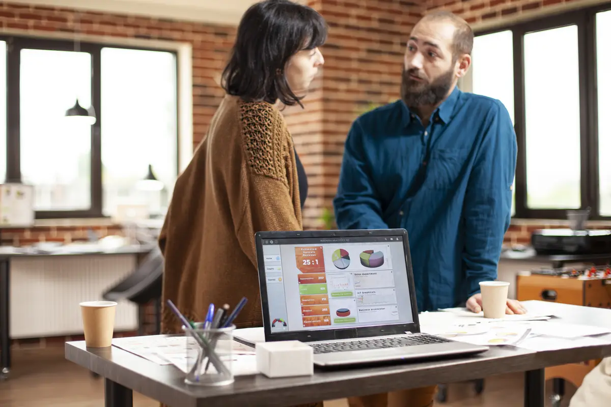 Laptop shows market analysis in office