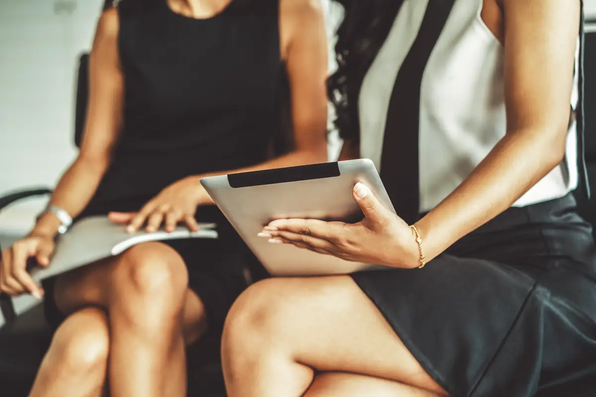 Two businesswomen discussing business in office uds