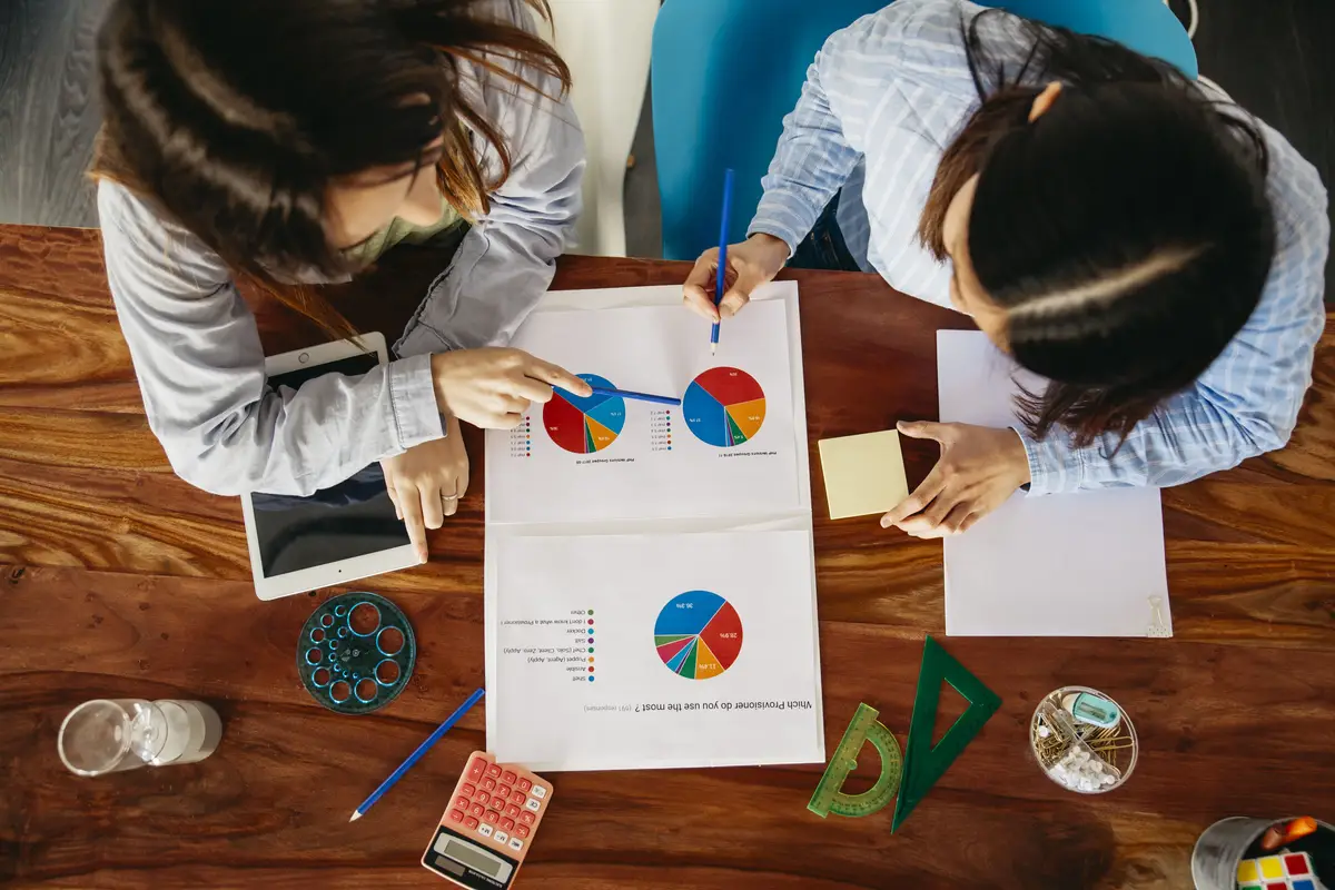 Women working with data and paper