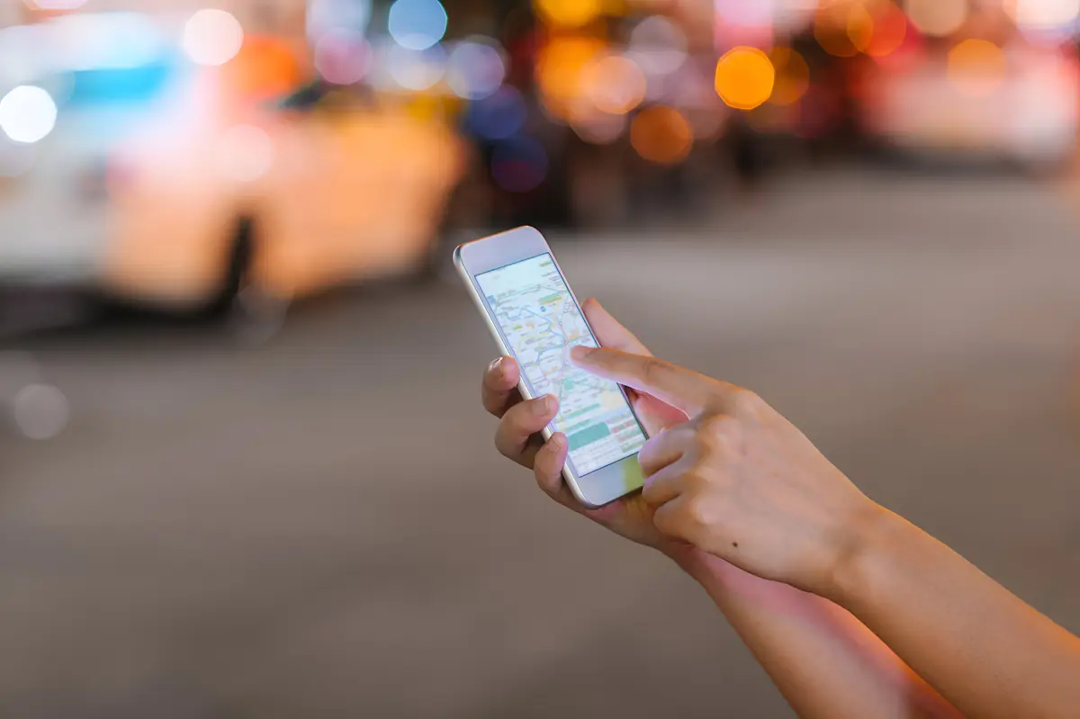 a person holding a phone with the word  app  on the screen
