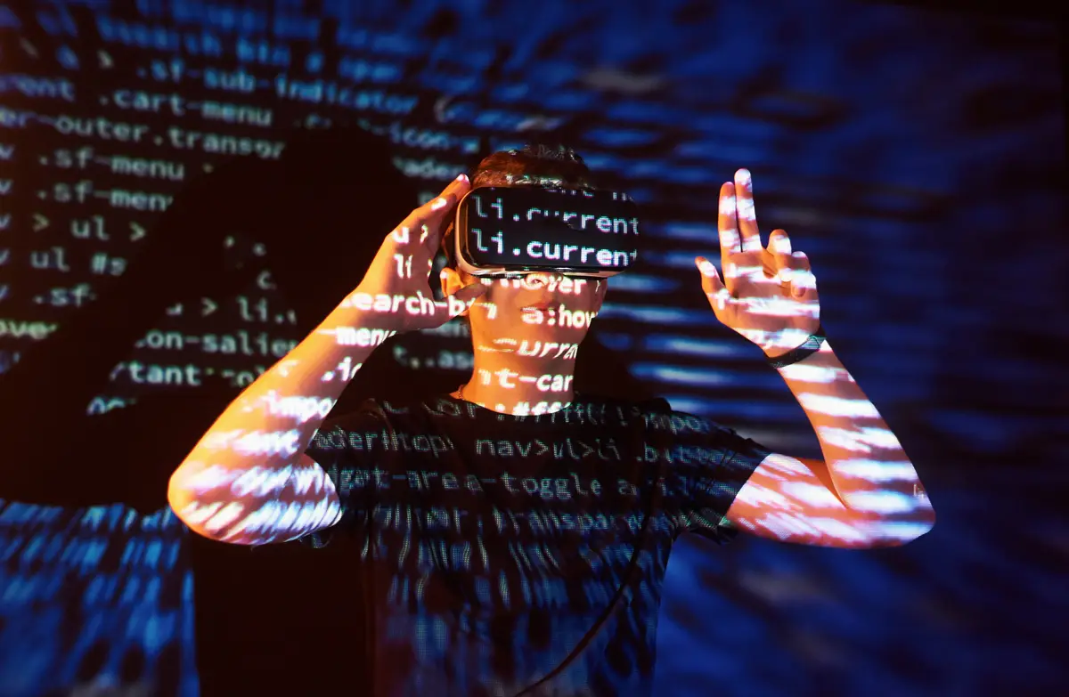 Double exposure of a caucasian man and Virtual reality VR headset is presumably a gamer or a hacker cracking the code into a secure network or server, with lines of code
