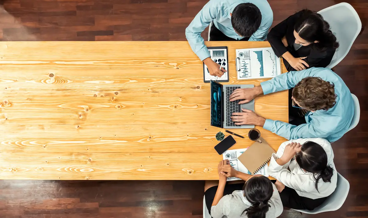 Panorama top view diverse analyst team analyzing financial data Meticulous