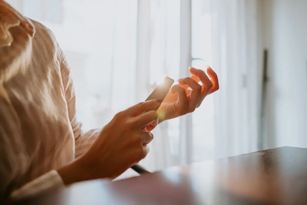 Midsection of woman holding ice cream at home