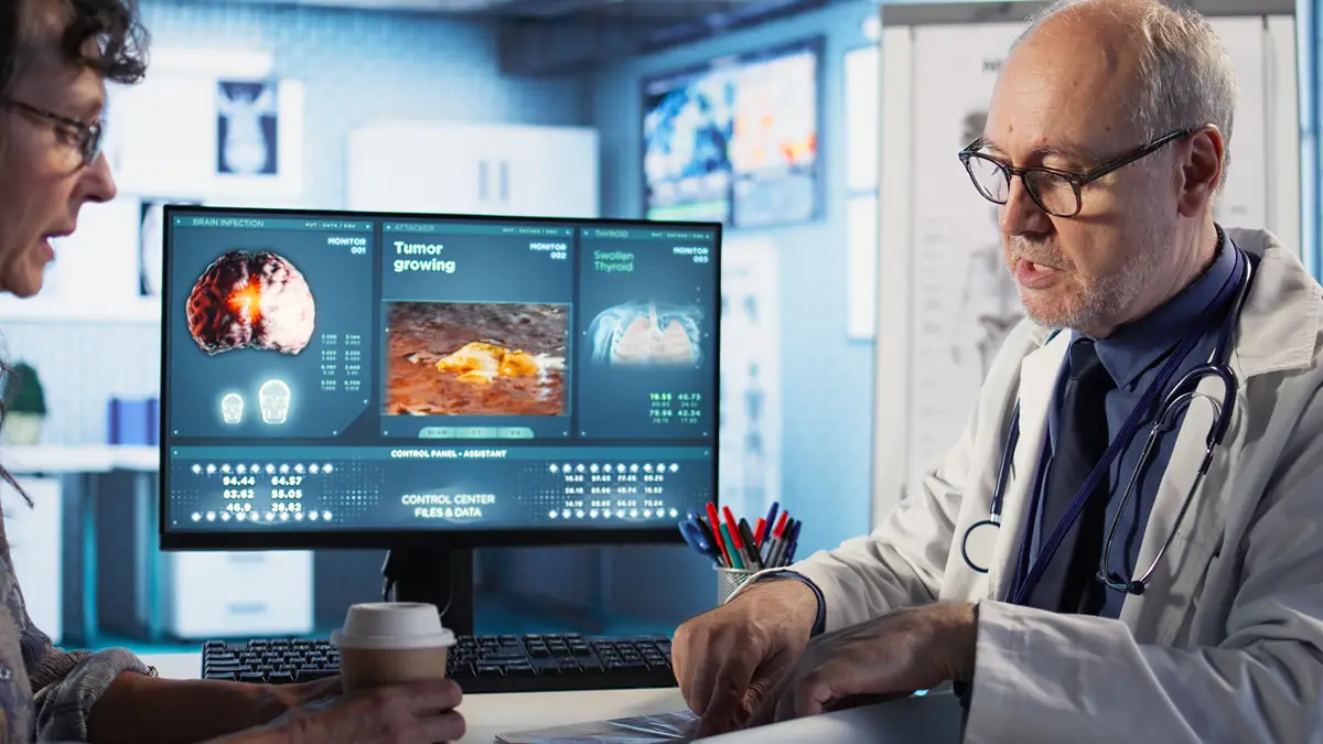 Specialist and old woman discuss x ray scan for preventive cancer medicine