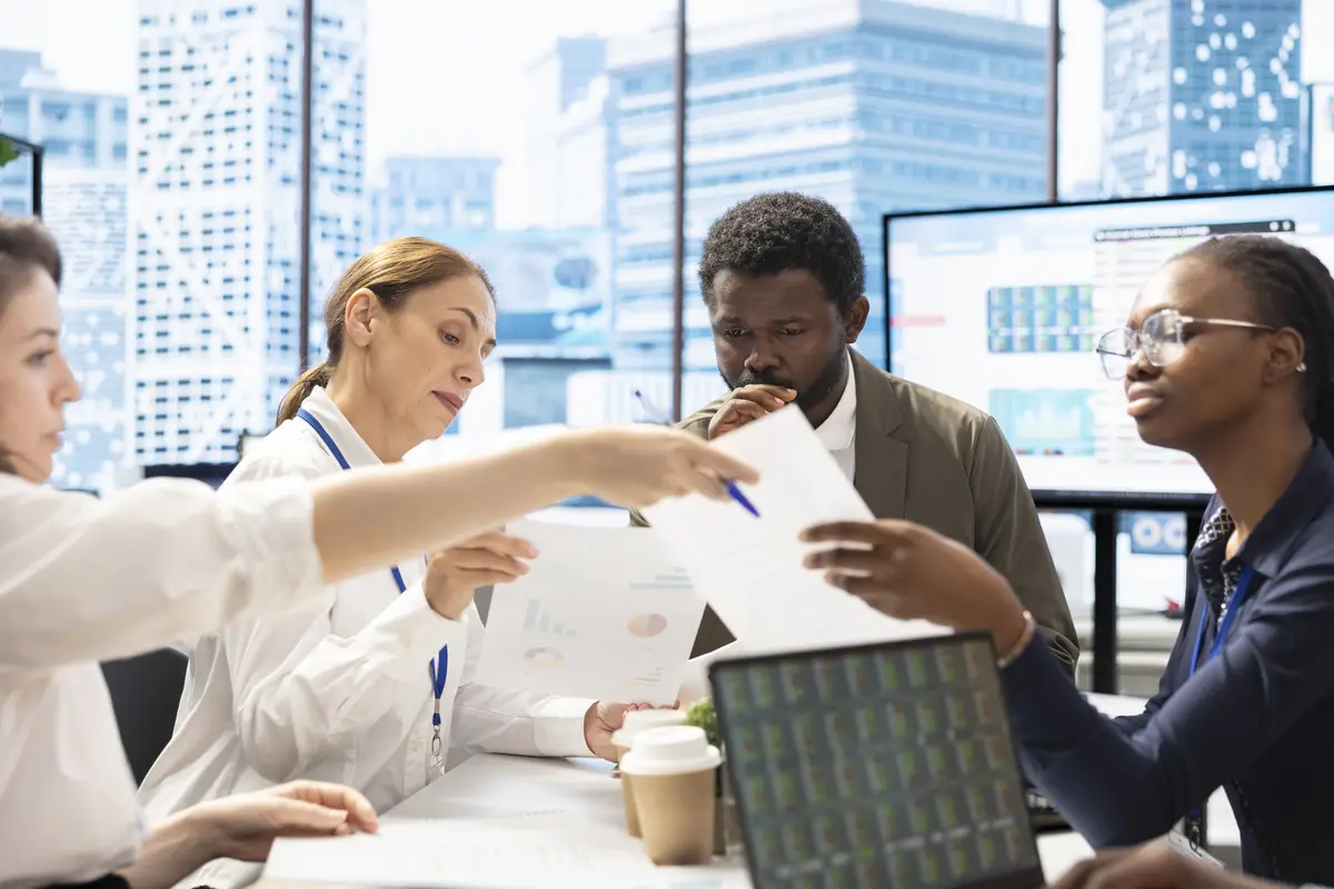 Management team gathering in the boardroom to review key performance indicators