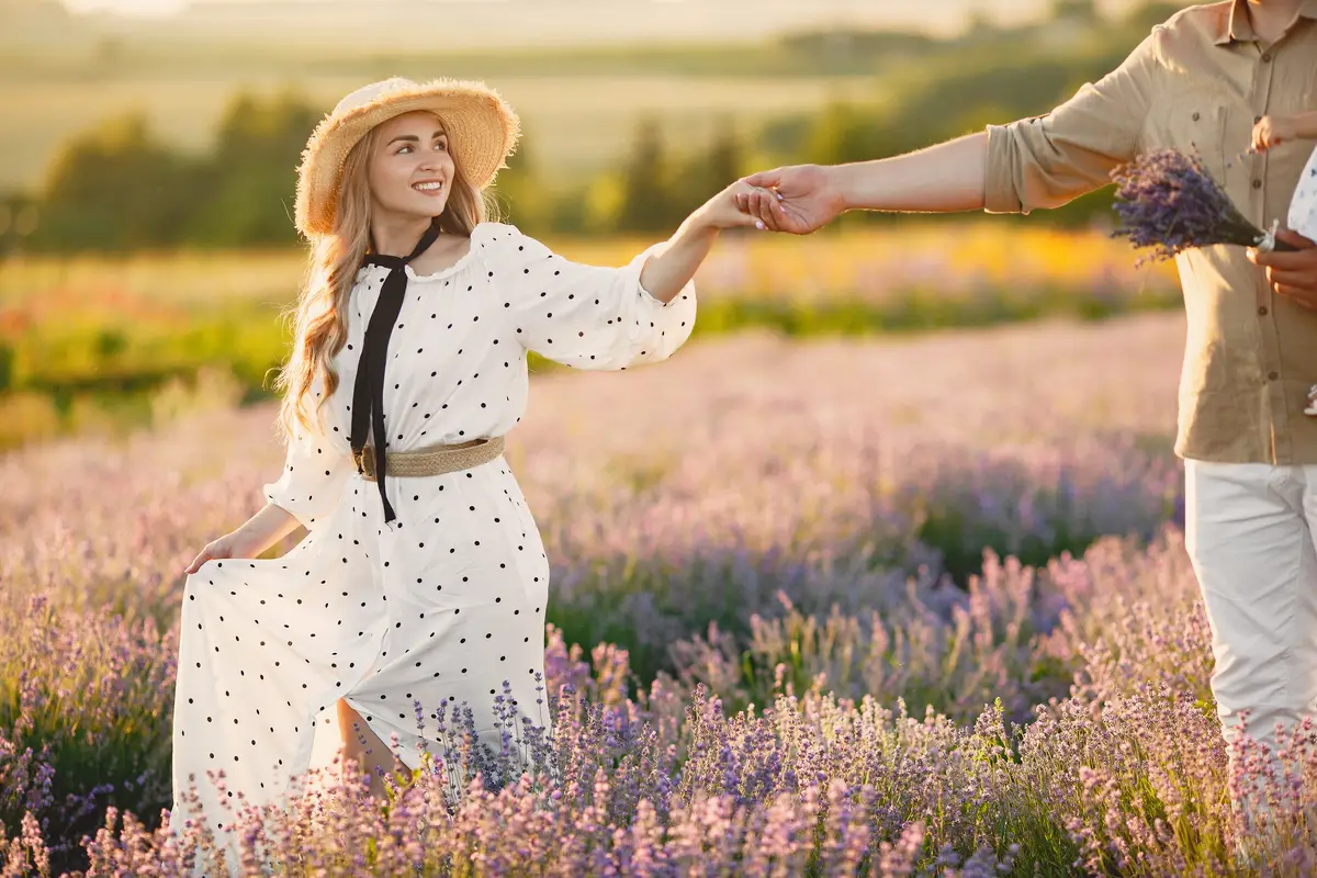 Provence couple relaxing in lavender field. Lady in a white dress.