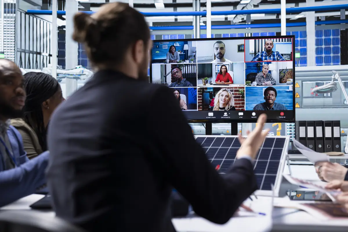 Photovoltaics factory management team chatting with investors in teleconference