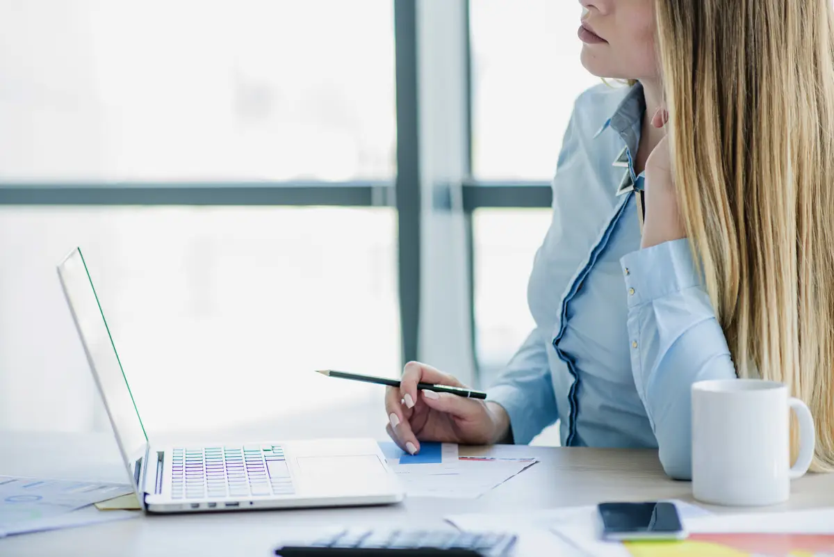 Secretary at desk with laptop