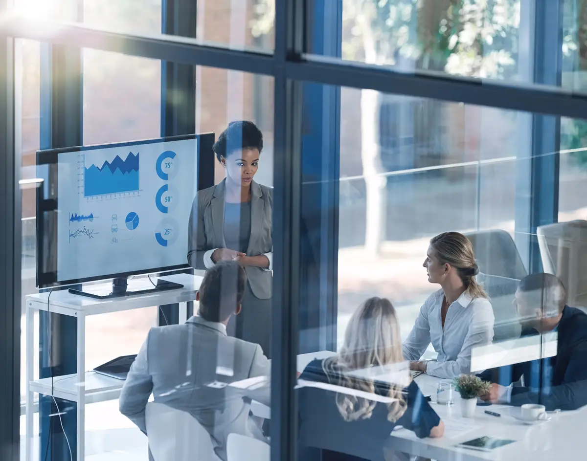 Yes you have a question Shot of a businesswoman discussing information with a group of businesspeople in the boardroom