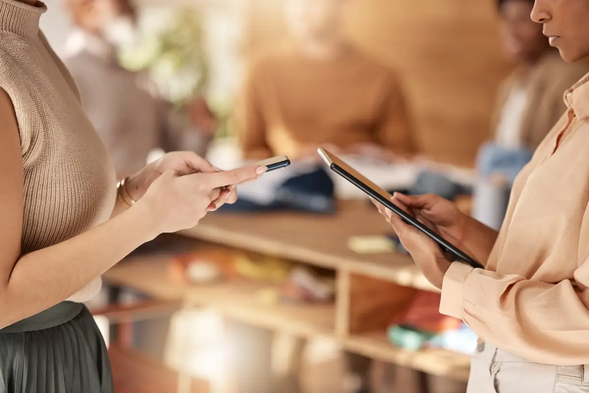 Business closeup and women with technology hands or share ideas for new project creativity or website launch Female employees consultants or coworkers with device smartphone or tablet in office