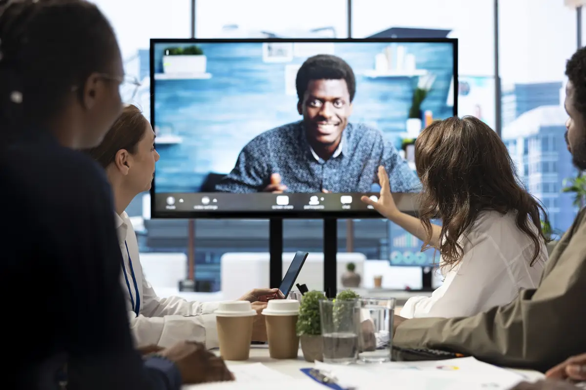 CEO leading a meeting on online teleconference call in the boardroom