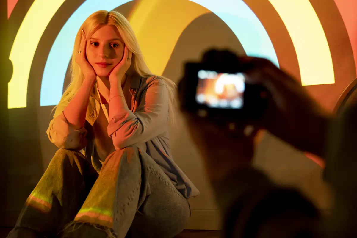 Couple taking photos in the light of movie projector