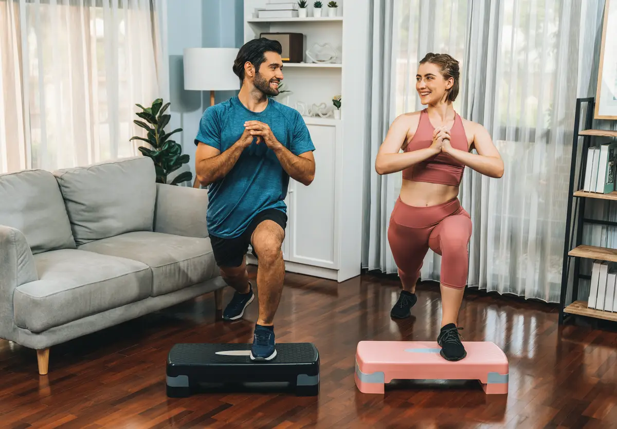 Athletic and sporty man doing squat at gaiety home exercise