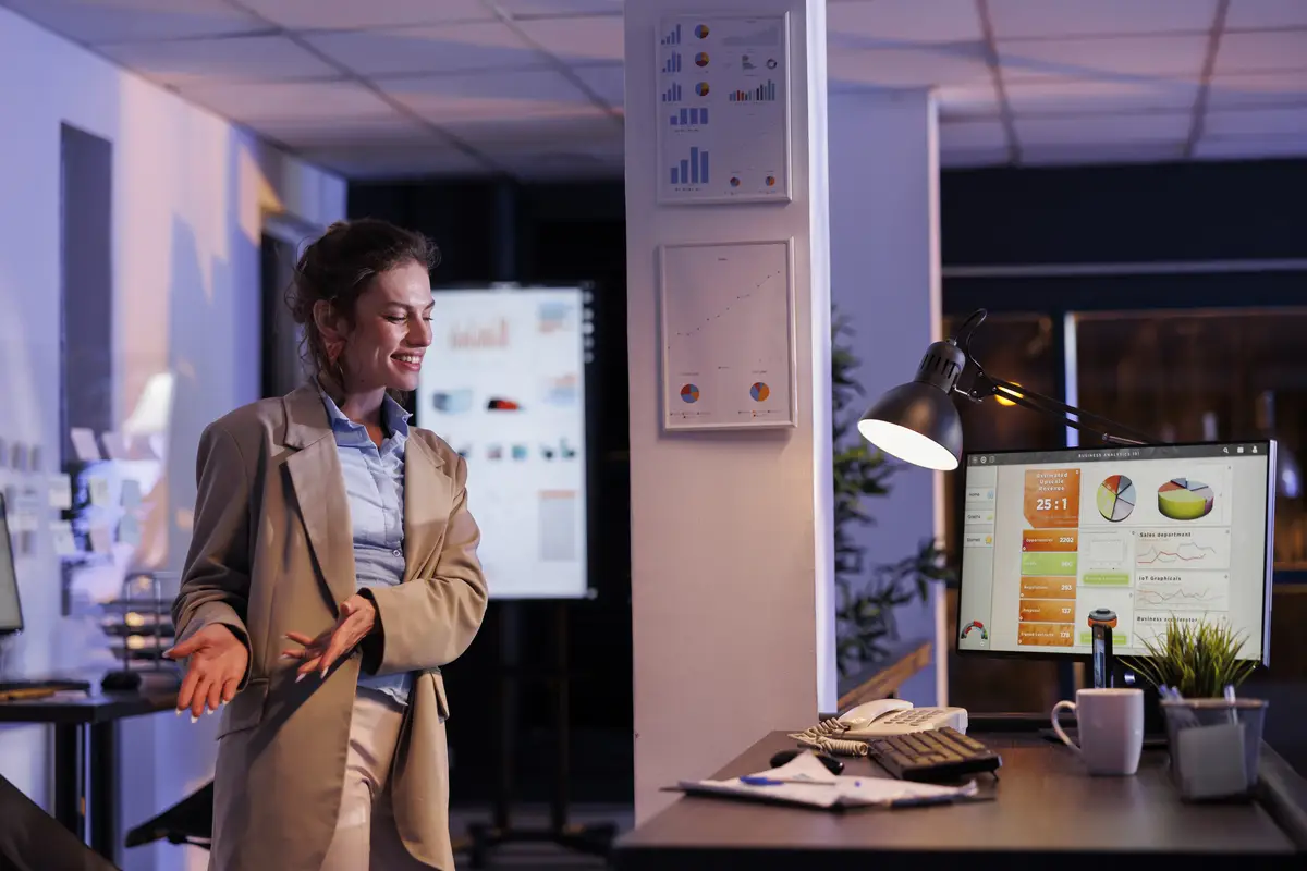 Smiling corporate employee talking with remote friend on videocall