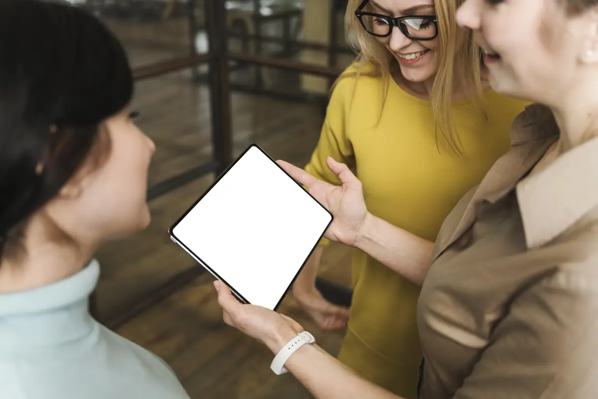 Smiley businesswomen with tablet during a meeting