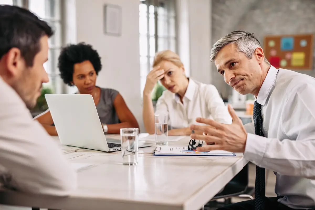 Angry businessman discussing with colleague during a meeting in the office