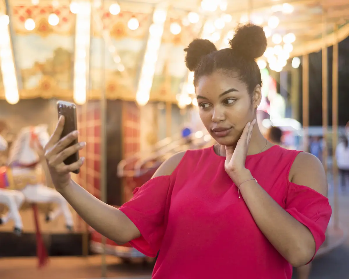 Beautiful young girl taking a selfie