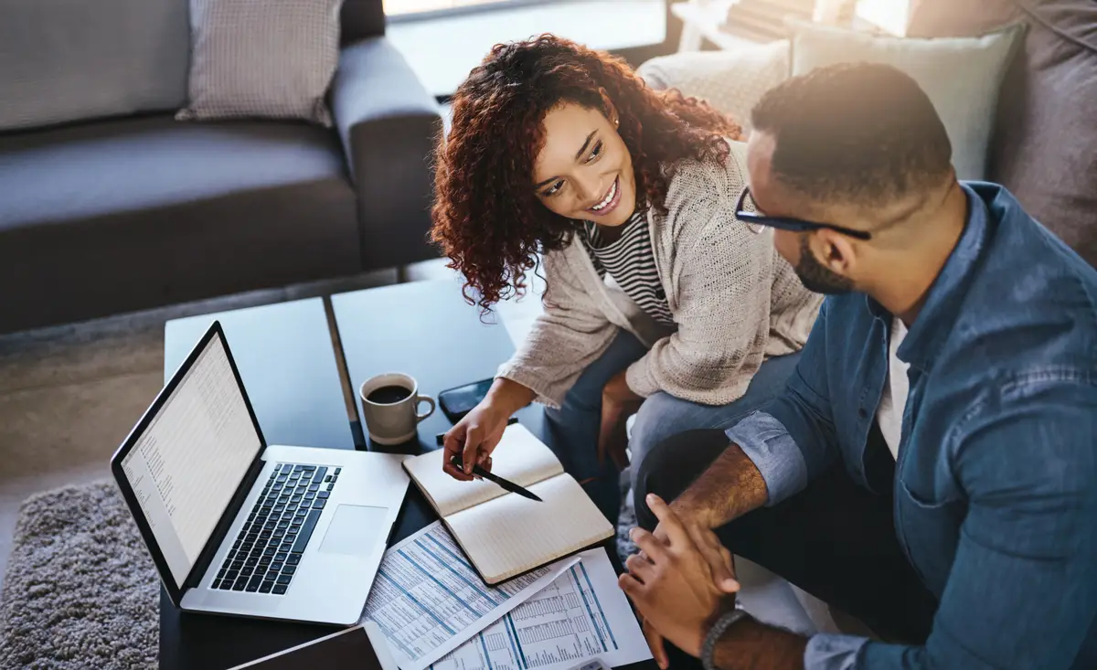 Book financial paperwork or couple with laptop budget documents or planning savings Finance loan writing notes or people organizing bills checklist and paying debt online with diary entry in home