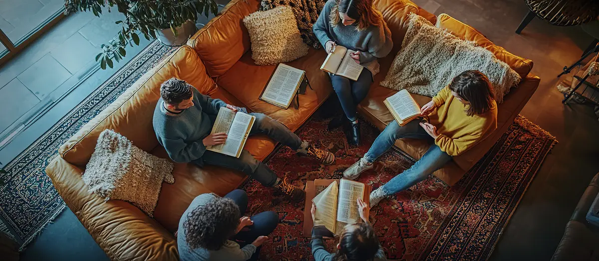 Group of people reading books together in a cozy setting