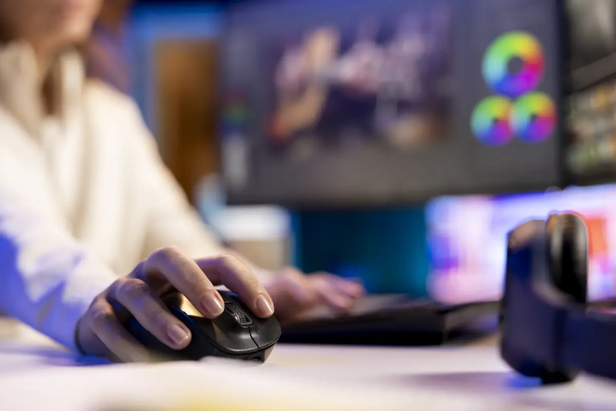 Focus on mouse used by post production videographer