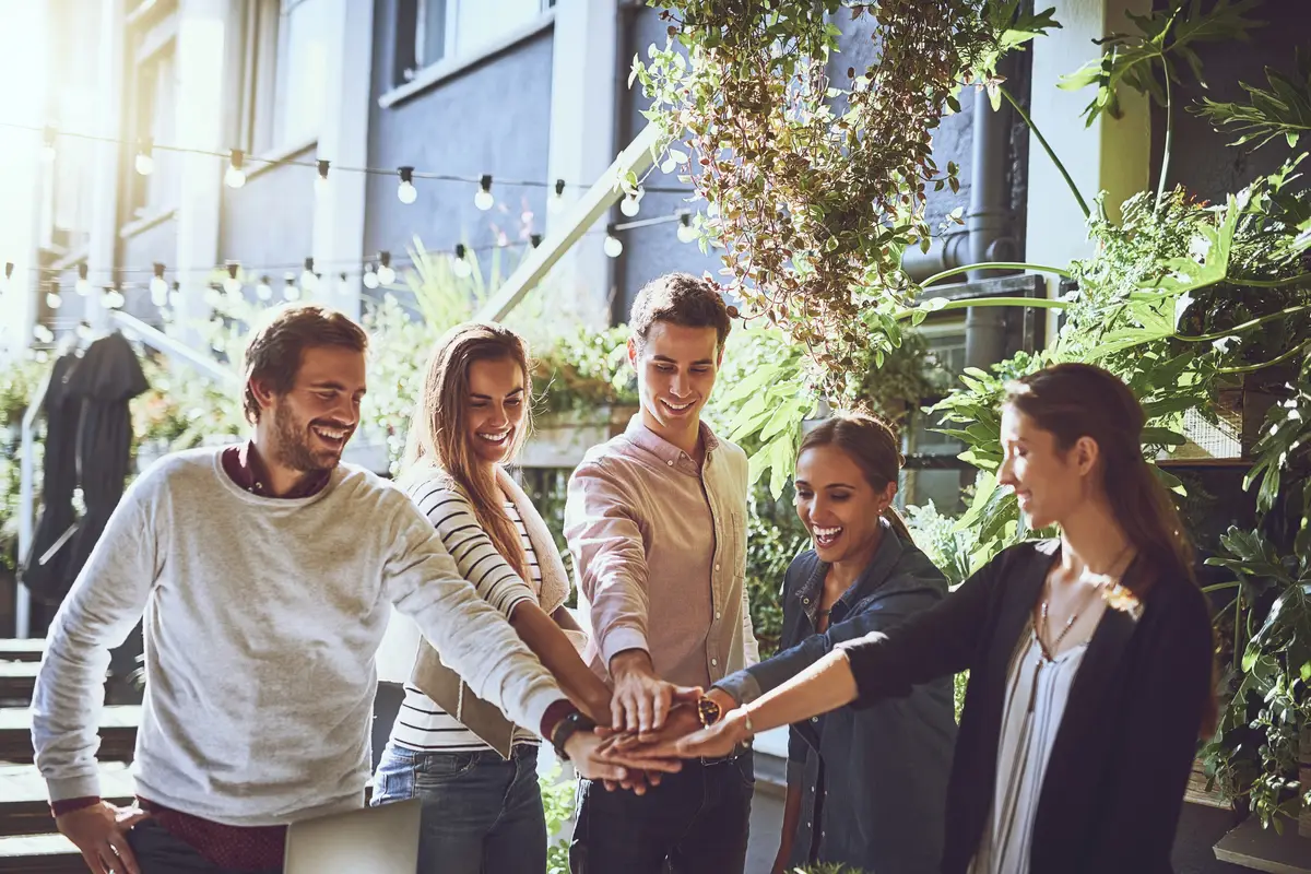 Huddle together and group of business people with agreement or celebration for success in meeting Collaboration trust and team building with solidarity for partnership or startup deal outdoor