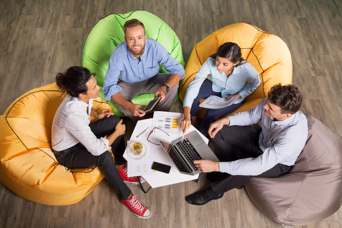 Four Young Colleagues Working on Beanbag Chairs