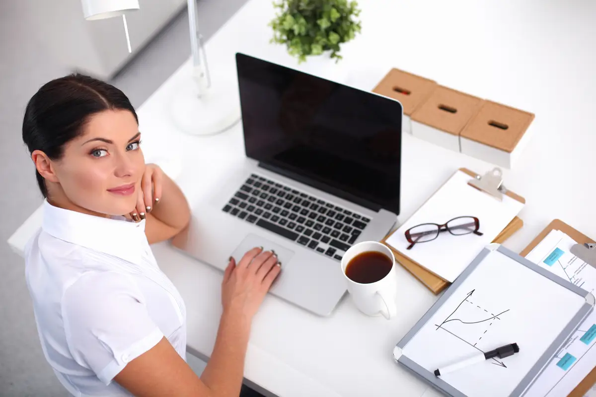 Portrait of a businesswoman sitting at desk with laptop