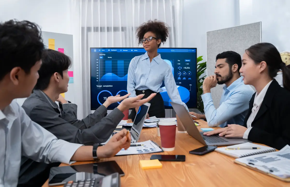 Young african businesswoman presenting data analysis dashboard on TV Concord