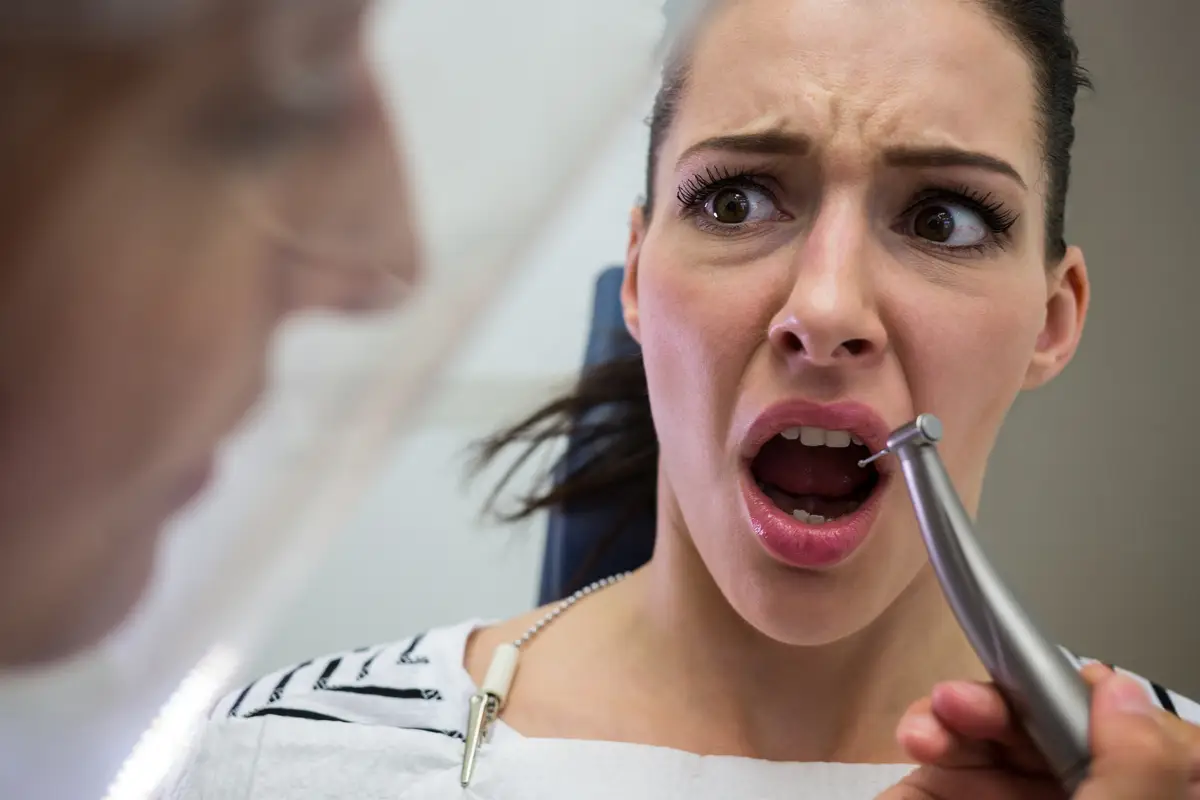 Young woman scared during a dental check-up