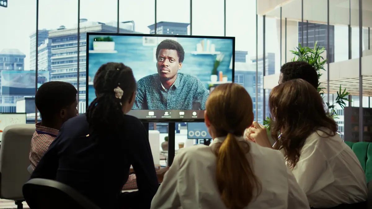 CEO leading a meeting on online teleconference call in the boardroom