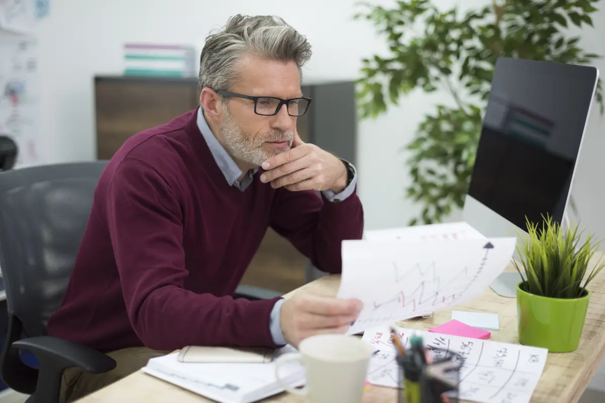 Hardworking man reading some important documents